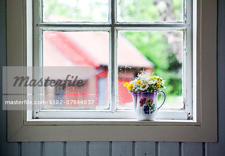 Wildflowers in jug on windowsill