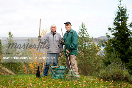 Senior couple raking leaves