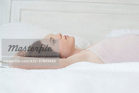 Woman lying on bed