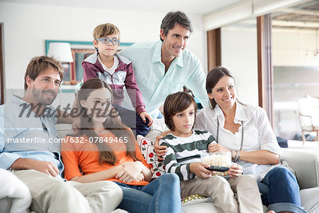 Extended family watching TV together