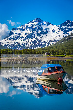 Scenic view of boat on lake and mountains in background, Ramfjord, Tromsoe, Troms, Northern Norway, Norway