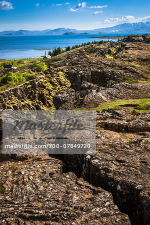 Scenic view of rocky terrain and mountains in the distance, Thingvellir, Iceland