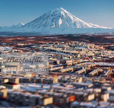 Petropavlovsk-Kamchatsky cityscape and Koryaksky volcano at sunrise. Far East, Russia. Image with an tilt-shift effect