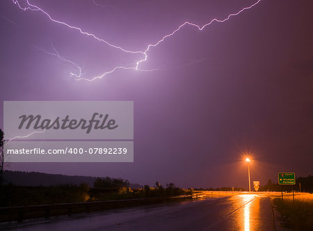 Lightning erupts over a lonley highway onramp in Nisquallly Valley