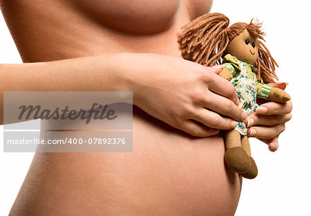 Pregnant woman holding a doll
