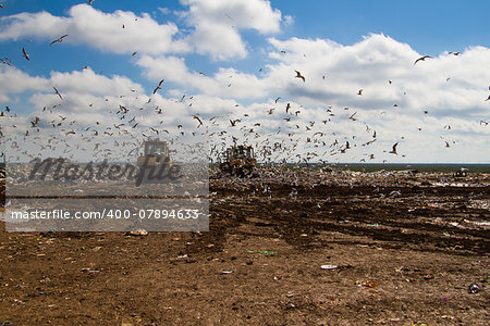 Shot of bulldozers working a landfill site