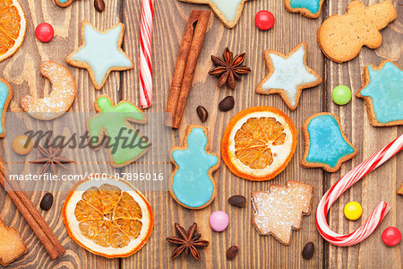 Christmas wooden background with spices and gingerbread cookies