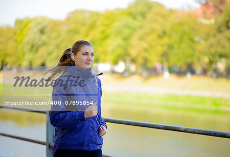 Young Beautiful Woman Running in the Autumn Park. Active Lifestyle