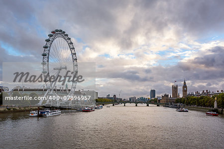 LONDON - OCTOBER 6: London Eye and Westminster Palace on October 6, 2014 in London. The largest Ferris Wheel in Europe, structure of the London Eye is 135 meters tall and 120 meters in diameter.