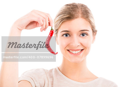 Beautiful girl smiling and holding a red chilli pepper, isolated over a white background