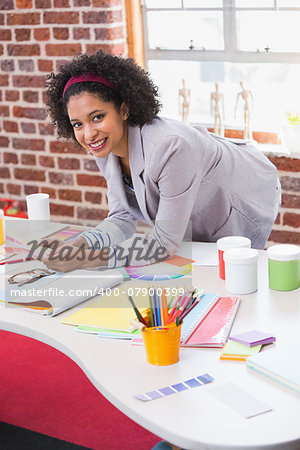 Portrait of female interior designer at office desk