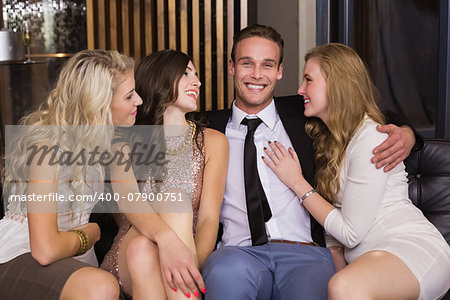 Happy friends smiling at camera at the bar