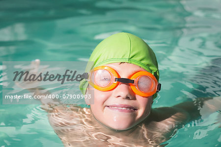 Cute kid swimming in the pool at the leisure center