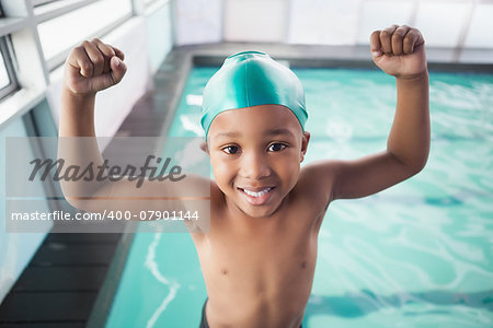 Cute little boy cheering at the pool at the leisure center