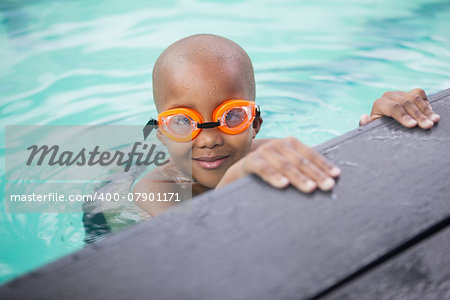 Little boy smiling in the pool at the leisure center