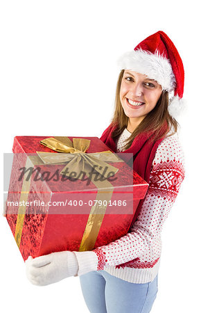 Young woman holding a gift while smiling at camera on white background