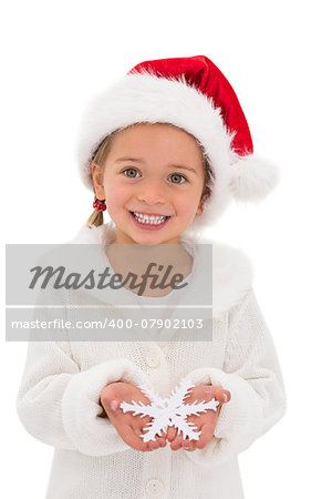 Festive little girl holding snowflake on white background