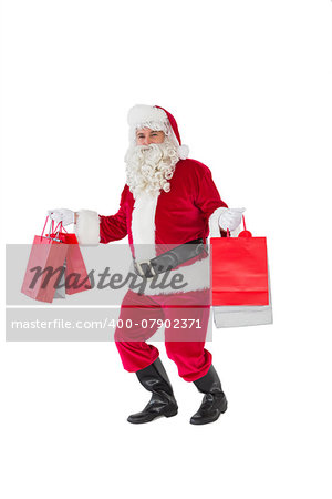 Smiling santa claus holding shopping bags on white background