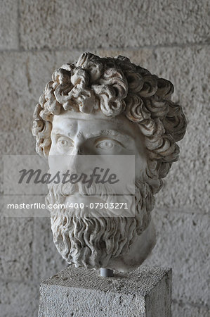Head of bearded man portrait greek statue marble bust at the ancient agora of Athens, Greece.