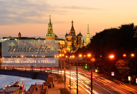 View of Kremlin towers, Saint Basils Cathedral and city highway at night, Moscow, Russia