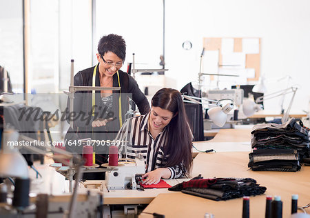 Two seamstresses at sewing machine in workshop