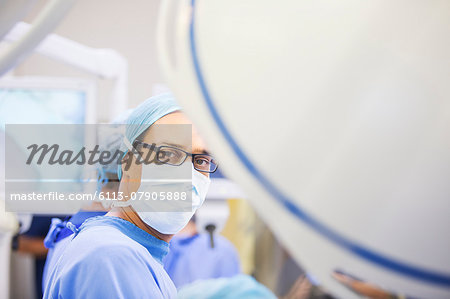 Portrait of masked surgeon in operating theater