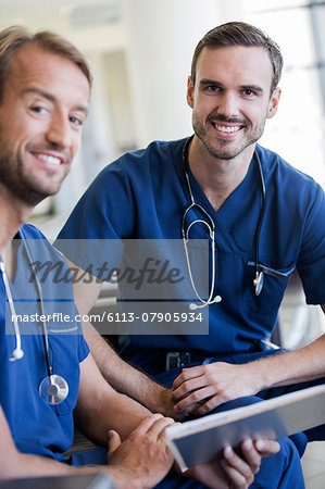 Portrait of two doctors with stethoscopes around necks in hospital