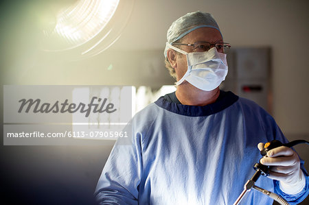 Surgeon performing laparoscopic surgery in operating theater