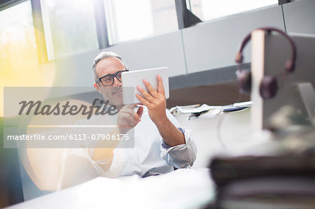 Businessman using digital tablet at office desk Businessman using digital tablet at office desk