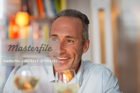 Older man drinking white wine