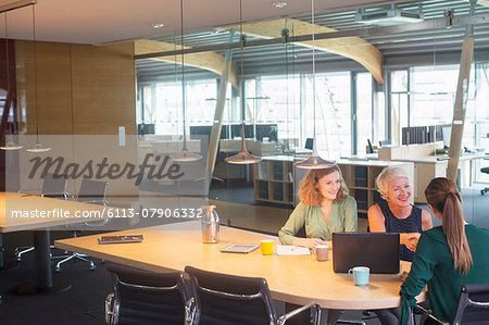 Businesswomen shaking hands in office meeting