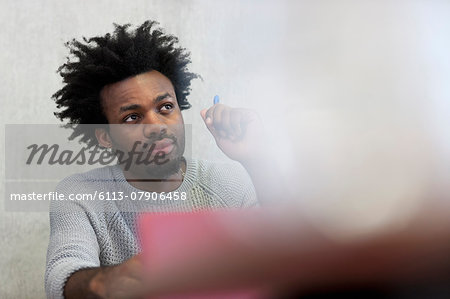 Focused university student listening during seminar in classroom Focused university student listening during seminar in classroom