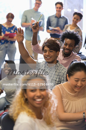 University students raising hands at IT seminar