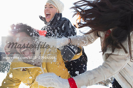 Friends enjoying snowball fight