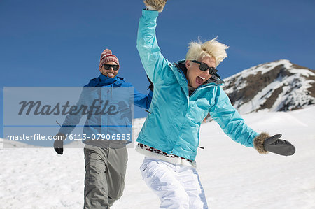 Exuberant couple playing in snow