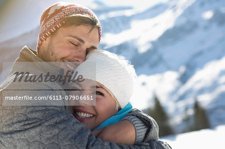 Couple hugging in snow