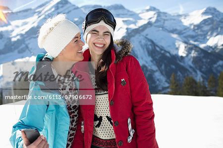 Women hugging and smiling in snow