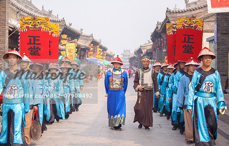 Pingyao, Shanxi, China. Traditional parade in the streets of the ancient town of Pingyao, UNESCO world heritage site