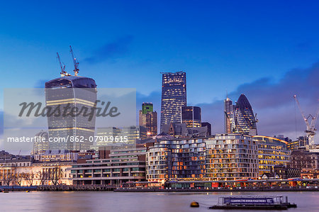 Europe, United Kingdom, England, London, City of London, skyline at dusk showing the Gherkin (30 St Mary Axe), the Cheesegrater (122 Leadenhall Street) and the Walkie-Talkie (20 Fenchurch Street) and the River Thames