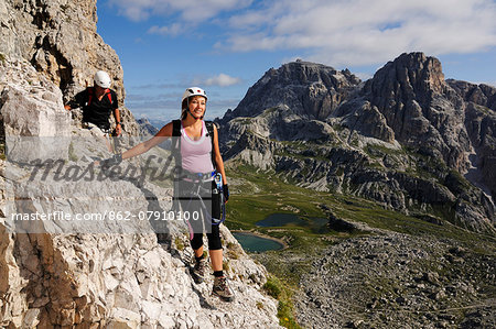 Climbing woman, Hochpustertal Valley, Sexten Dolomites, South Tyrol, Italy MR