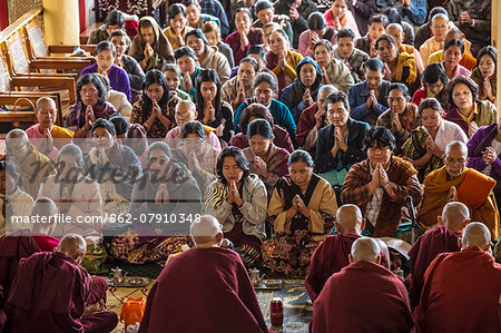 Myanmar, Shan state, Pindaya. Local women praying with buddhist monks