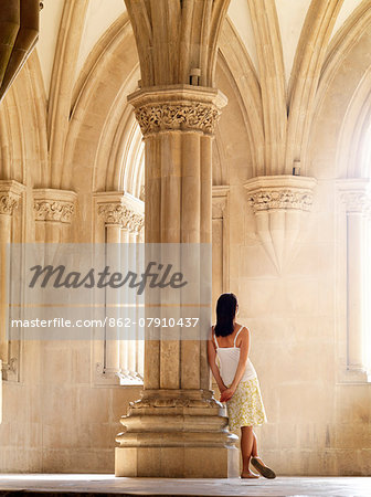 Portugal, Estremadura, Alcobaca, Santa Maria de Alcobaca Monastery, Woman leaning on column (UNESCO World Heritage) (MR)
