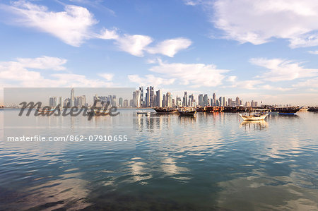 Qatar, Doha. Cityscape with fishing boats in the foreground