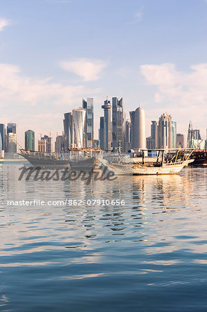 Qatar, Doha. Cityscape with fishing boats in the foreground