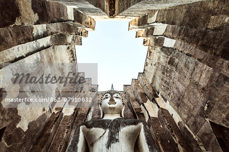 Thailand, Sukhothai Historical Park. Wat Si Chum temple with giant Buddha statue, low angle view