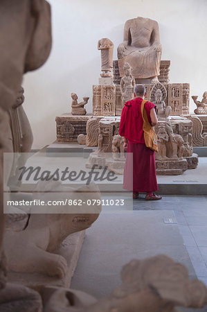 Monk looking at relics at Cham Museum, Da Nang, Vietnam