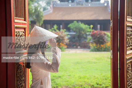 Woman wearing Ao Dai dress at Thai Binh Reading Pavilion inside Citadel, Hue, Thua Thien-Hue, Vietnam (MR)