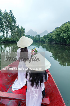 Vietnam, Perfume river. Young vietnamese girls on a boat going to the Perfume pagoda (MR)