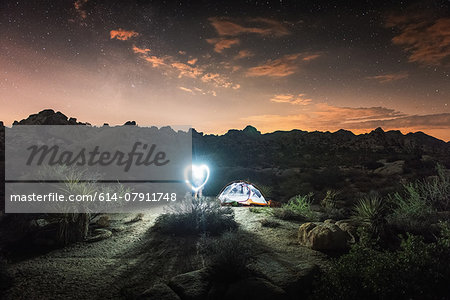 Illuminated tent by night, Joshua Tree National Park, California, US