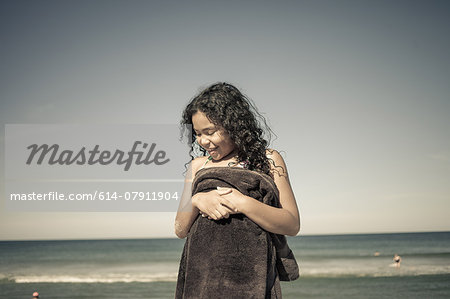 Girl wrapped in towel on beach, Truro, Massachusetts, Cape Cod, USA